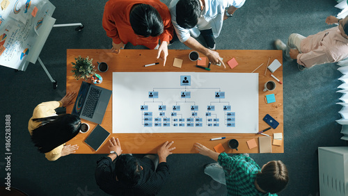 Cuadro en lienzo A diverse team collaborates in a modern office, analyzing an organizational structure on a large chart