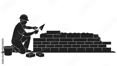 A construction worker carefully lays bricks to build a sturdy wall