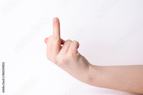 Hand making gesture in front of plain background