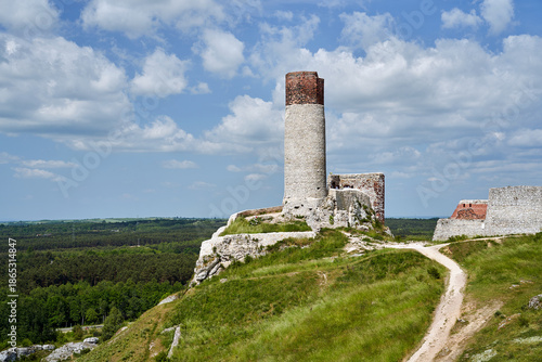 Limestone rocks and ruins of a medieval castle with a tower in Olsztyn