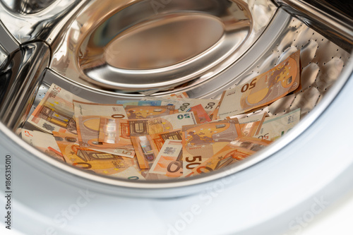 Money placed inside a washing machine drum, concept for money laundering