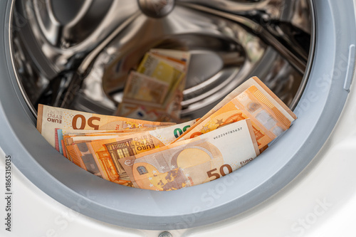 Money found in a washing machine at a home in Europe, concept for money laundering