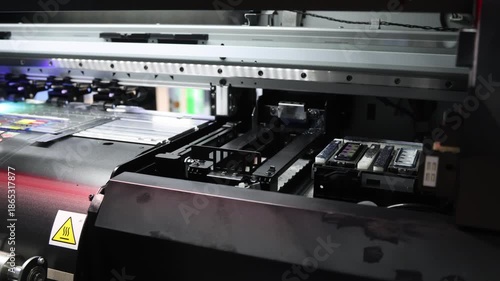 Industry printer. High quality Industrial inkjet printer in operation. printing patterns on large sheet of fabric or paper. Automate printer for modern textile printing and digital print technology.