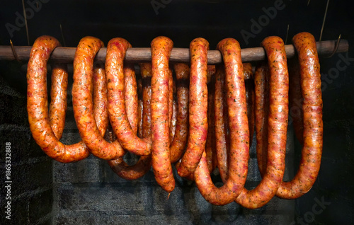 Smoking sausages for Christmas in a traditional smokehouse.