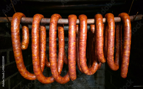 Smoking sausages for Christmas in a traditional smokehouse.