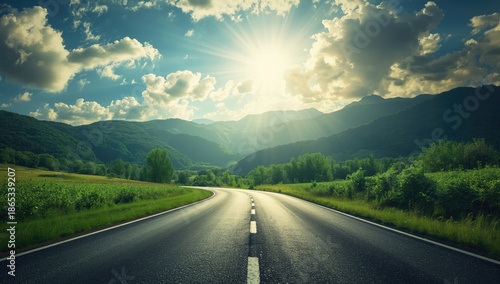 Scenic asphalt pathway cutting across verdant mountain terrain beneath overcast skies, suitable for road maintenance planning