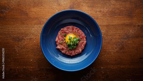 Raw beef dish in a blue bow...