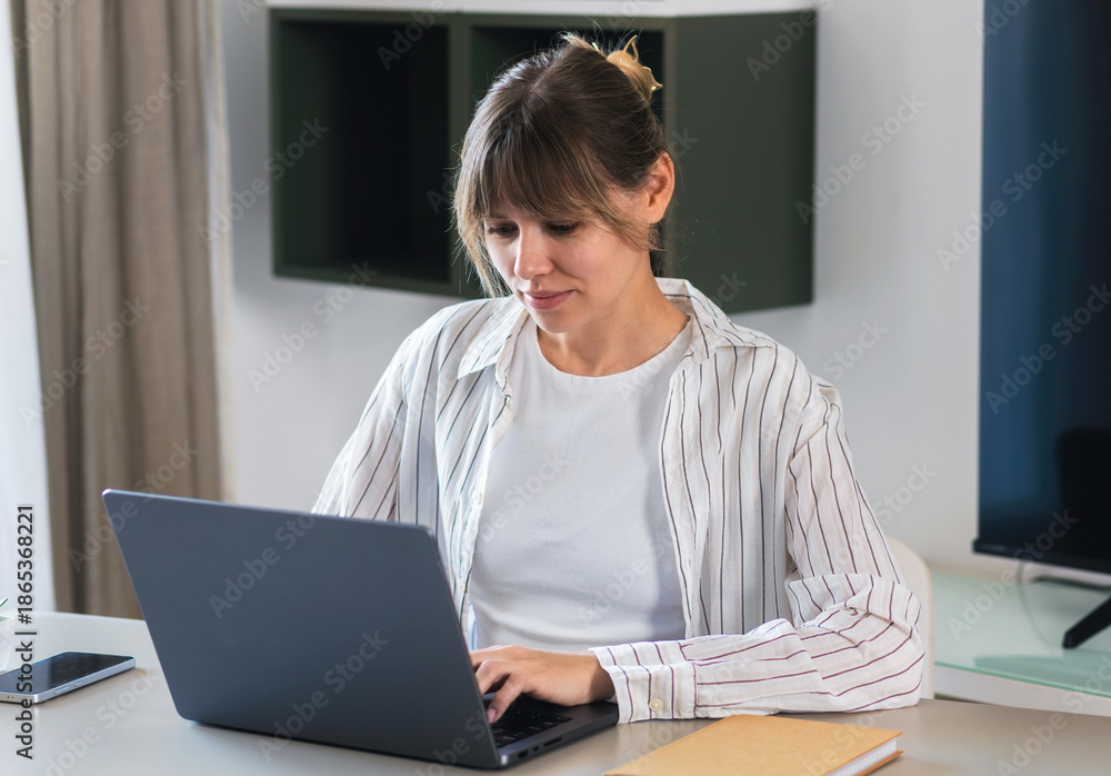 Fototapeta premium Woman working on laptop in home office