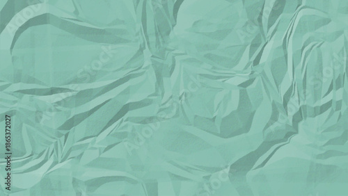 A close up view of a mint green textured surface with irregular patterns and wrinkled and crumpled paper texture.