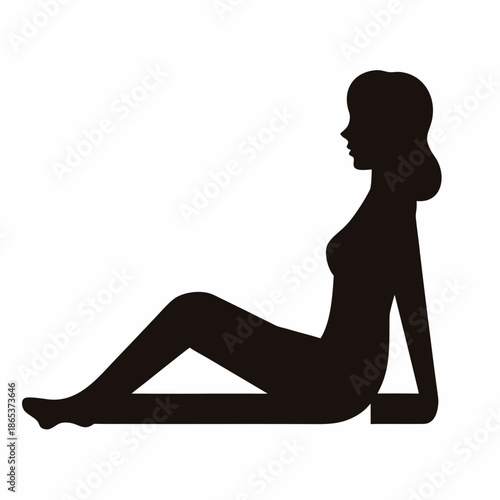 Silhouette of a woman sitting on the floor looking relaxed or thoughtful