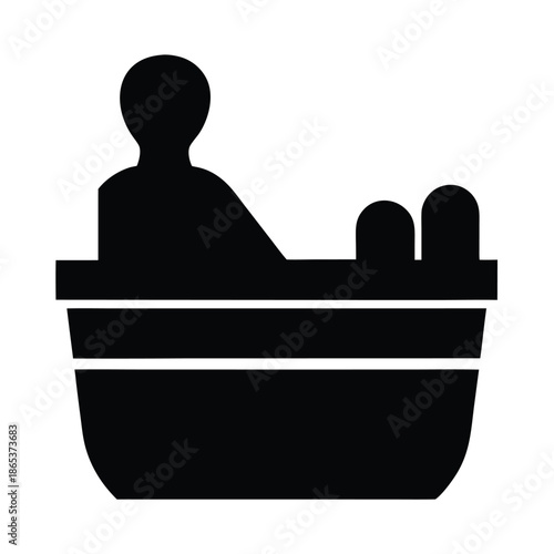 Silhouette of person relaxing in a bathtub with head and knees showing