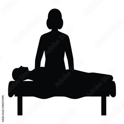 Silhouette of a Massage Therapist Giving a Back Massage on a Table