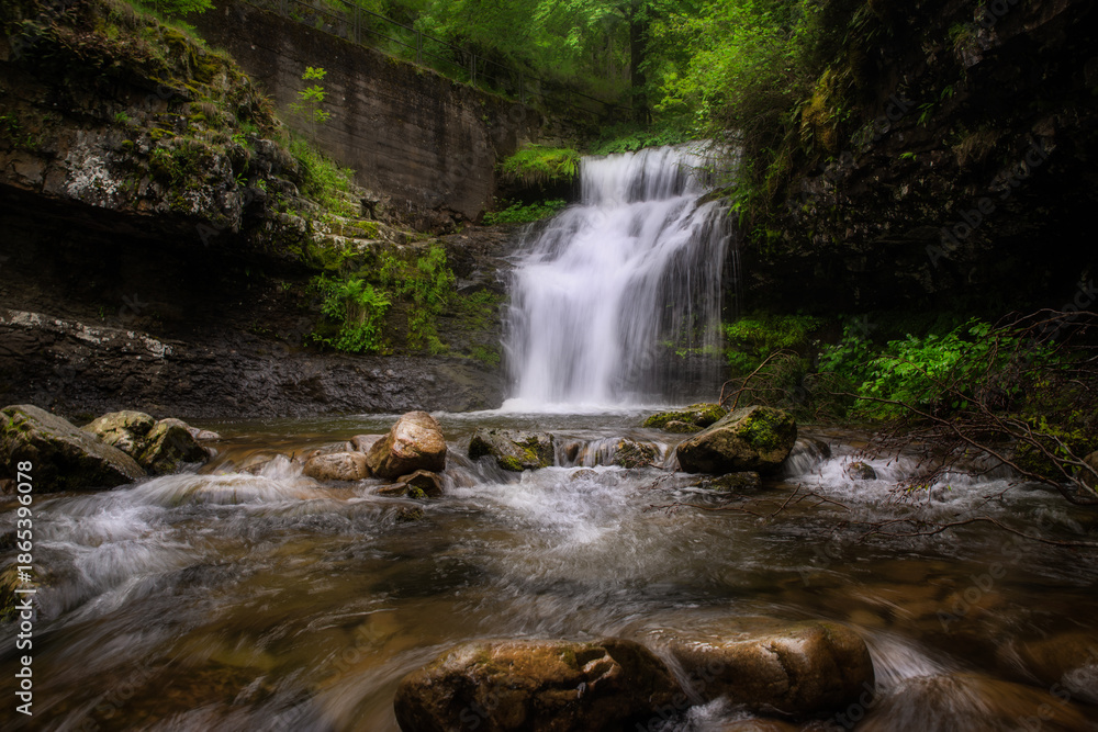 Fototapeta premium Long Exposure Waterfall in the Lush Green Forests of La Rioja, Spain