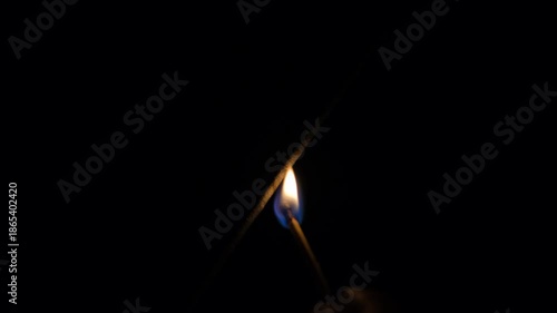 New Year sparklers glowing in darkness. Glowing sparklers on black background. Bright sparklers glowing on black background