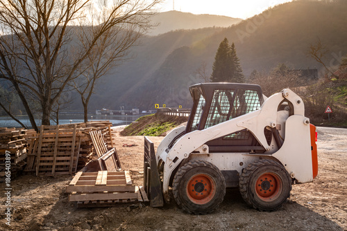 Small skid steer loader on construction site