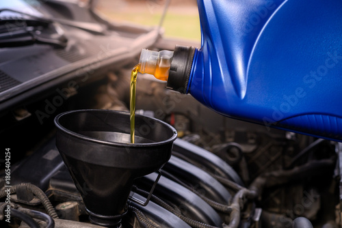 Pouring oil into a car engine