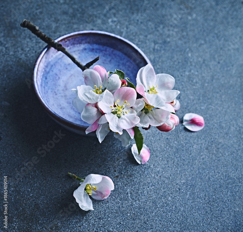 Beautiful apple blossoms on a small ceramic cup. Copy space