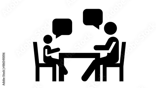 Two people talking at a table