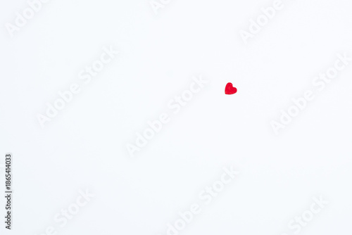 Single small red heart on a clean white background with large copy space. Minimal romantic concept symbolizing love, affection, emotion, Valentine’s Day, relationships, and tenderness. 