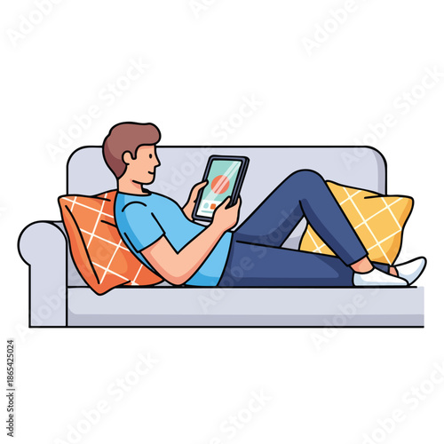 A person reclines on a couch using a tablet. Pillows flank the relaxing figure