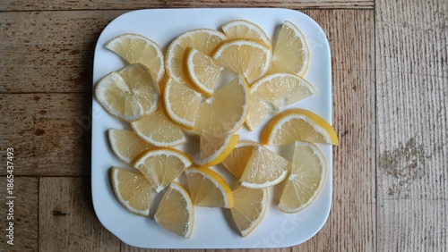 Fresh Lemon Slices on a White Plate: A Bright Decoration for Dishes and Drinks Image for Cooking and Recipes