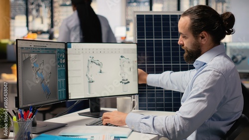 Obraz na płótnie Sustainability RD expert uses CAD program on PC to design production lines for solar panel assembly