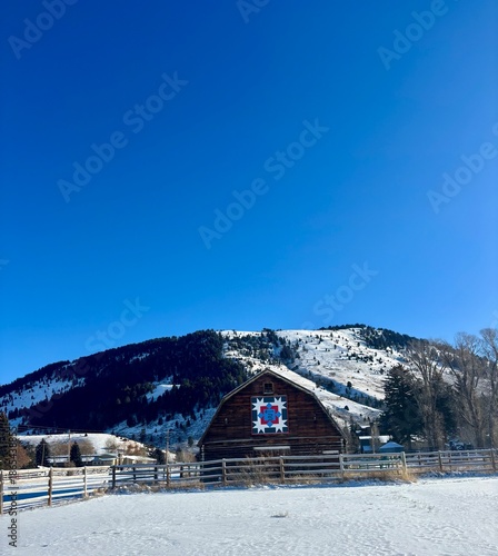 Snowy Historic Barn in Jackson Hole on a blue bird, winter day with mountain in background