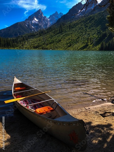 Canoeing in Front of Picturesque Snowy Mountains on an Alpine Lake