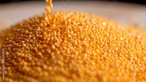 Vibrant orange and yellow dry lentils cascading into a bountiful heap showcasing the rich texture and natural abundance of these healthy plantbased legumes perfect for culinary and nutritional themes.