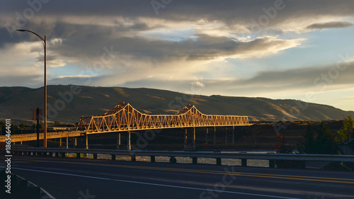 Steel Cantilever Bridge at Sunset Over Wide River