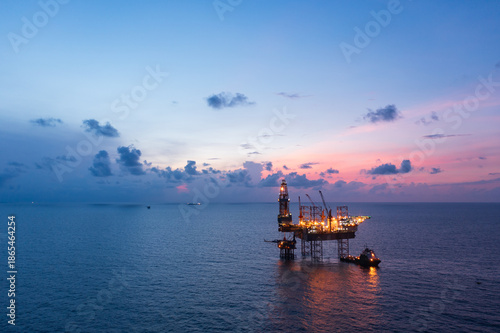 Tableau sur toile Aerial view of offshore jack up rig in a shipyard during sunset for oil and gas exploration and production