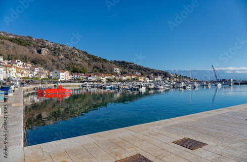Baska harbor with red tourist submarine and boats