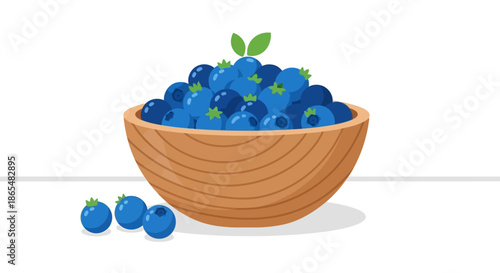 A wooden bowl full of fresh blueberries with a few berries scattered nearby.