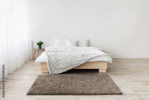 Wallpaper Mural Home nordic interior. Minimalist design with panoramic window. King size bed on wooden floor, table with green plants in pots, carpet on white wall background in bedroom interior, empty space Torontodigital.ca