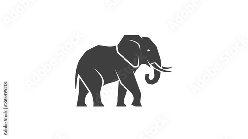 Silhouette of a walking elephant with curved tusks and raised trunk.