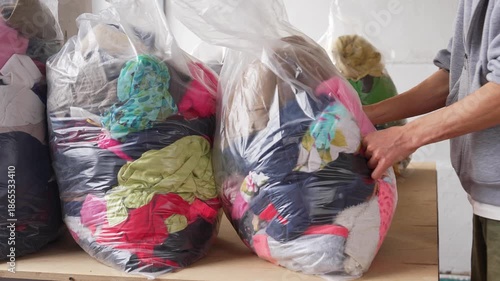 Bags full of used clothing ready for sorting and textile recycling. Sustainable fashion concept, reuse of garments, eco friendly lifestyle, circular economy and waste reduction
