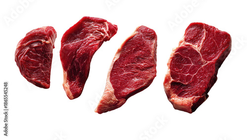 Four raw, red beef cuts, marbled and isolated on black