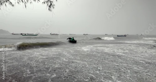 Person in a small boat being tossed by a large wave during a stormy day ( slow motion) 