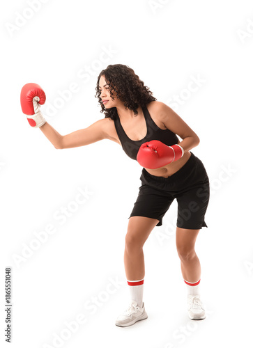 Female African-American boxer fighting on white background