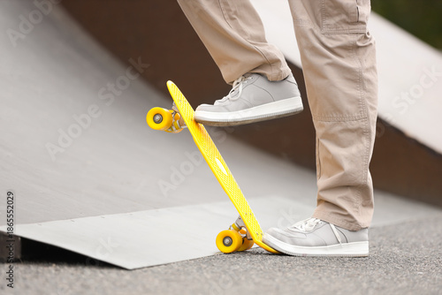 Young man riding skateboard...