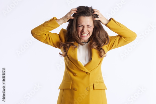 Obraz na plátne A professional woman in a yellow blazer, hands on her head with eyes closed and teeth bared, clearly expresses overwhelming stress and frustration from her demanding work life