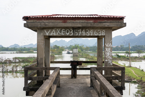 Concrete floodgate structure over river in rural Ninh Binh, Vietnam