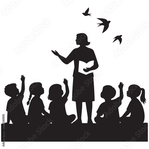 Silhouette of female teacher reading to group of children with flying birds.