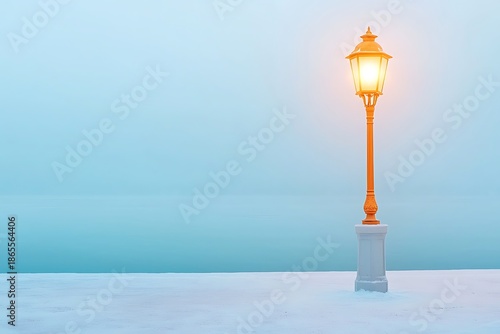 Vintage lamp post glowing softly amidst tranquil snow-covered landscape at twilight