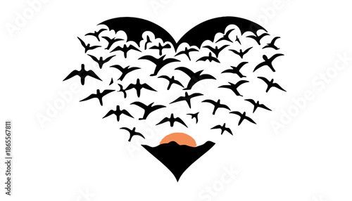 Heart shaped flock of birds flying at sunset