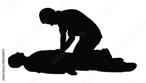 Silhouette of a person performing CPR on another