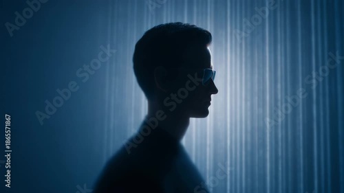 Silhouette man profile glasses cyber futuristic technology blue digital abstract dark shadow anonymous front view sunglasses neon glow streak rain virtual sci fi modern stylish minimal portrait