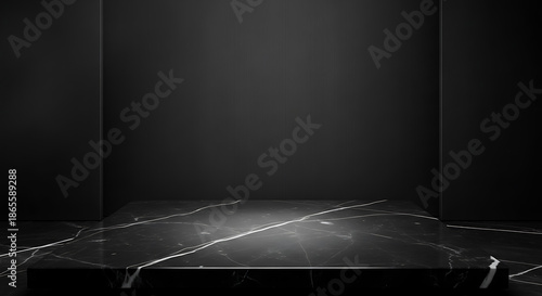 Dark marble platform with white veins against a black studio background black marble