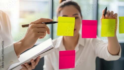 Collaborative team members engage in a strategic brainstorming session, meticulously planning innovative project development and problem-solving using visual aids