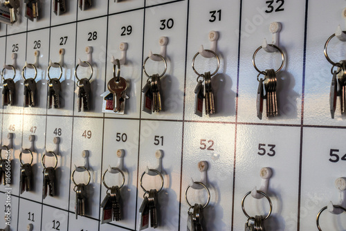 Wallpaper Mural Marilia, SP, Brazil. June 27, 2025. Keys organized on a numbered rack. One key with a house-shaped fob stands out, representing concepts like new home, real estate, finding the right solution Torontodigital.ca